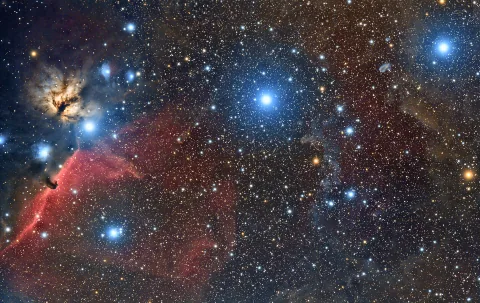 Orion's Belt and sword in a dark blue star field.
