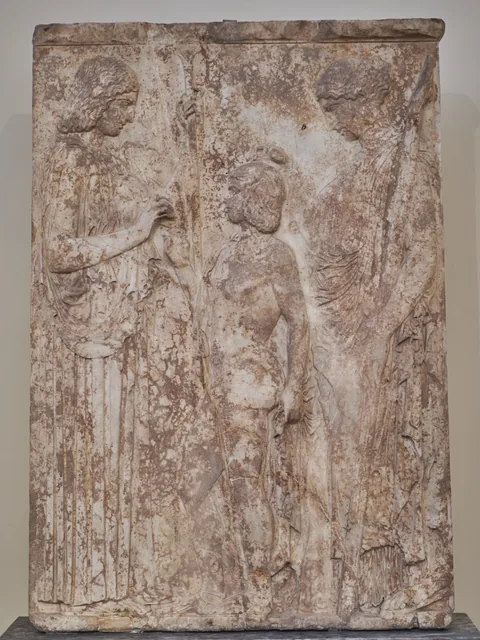 Relief sculpture of Demeter and Persephone flanking Triptolemos.
