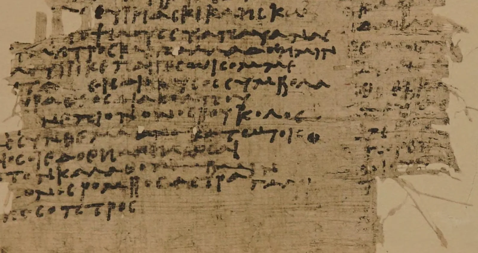 The lower half of a torn papyrus sheet, its left column dense with lines of brown Greek handwriting, the right edge frayed into fibres, with the last short line ending in the word for mirror.