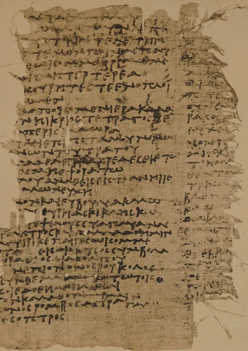 A whole papyrus fragment, taller than wide, its edges ragged: a broad column of Greek handwriting on the left and a narrow strip of line-beginnings from the next column on the right.