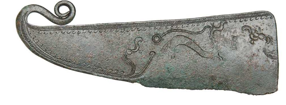 Photograph of the Hvolris bronze razor with its surviving handle and cutting edge.