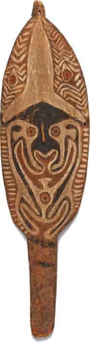 An oval hohao board on a short handle, carved with a dark face framed in zigzag bands.