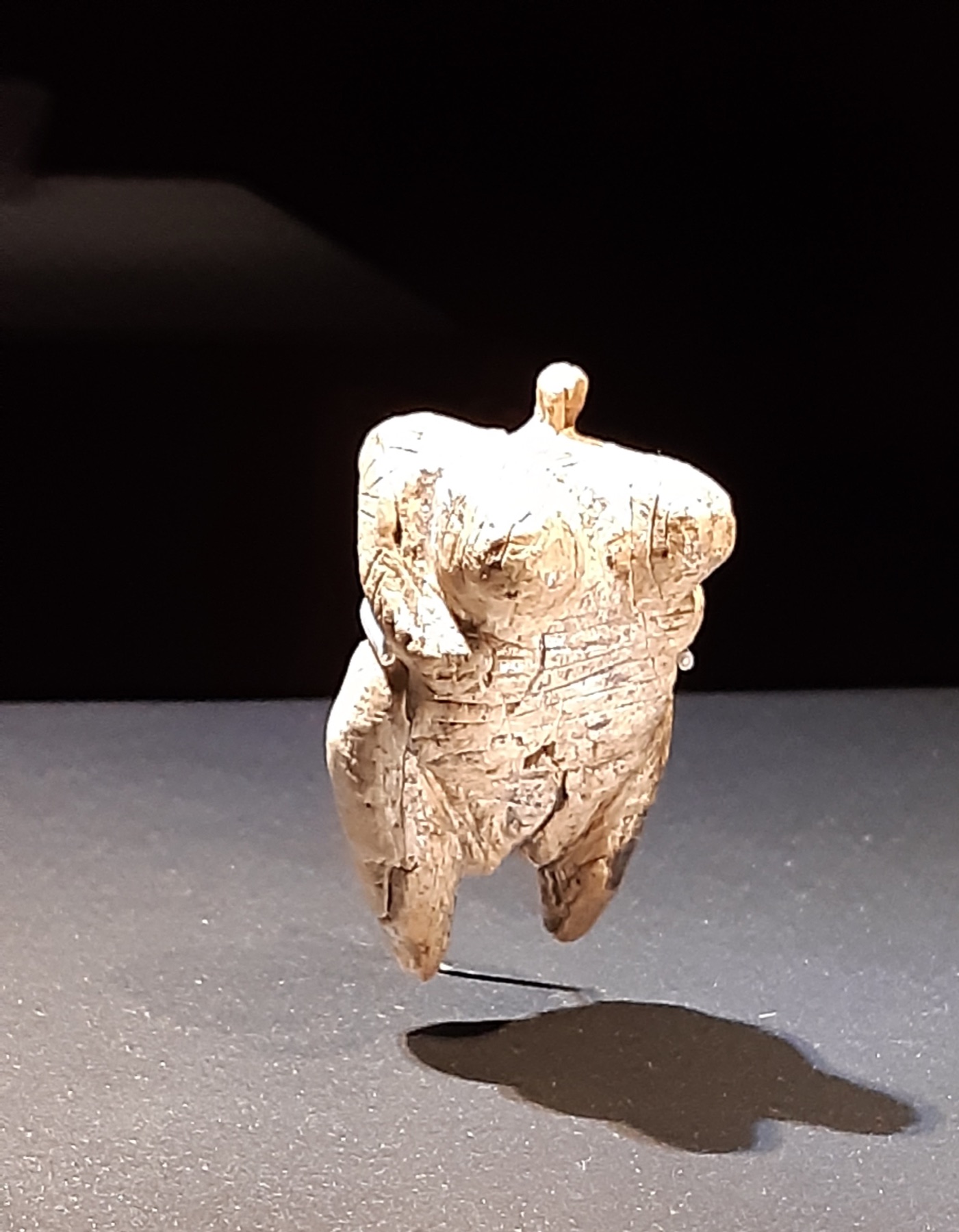 The Hohle Fels Venus, a small mammoth-ivory female figure with a perforated loop instead of a head.