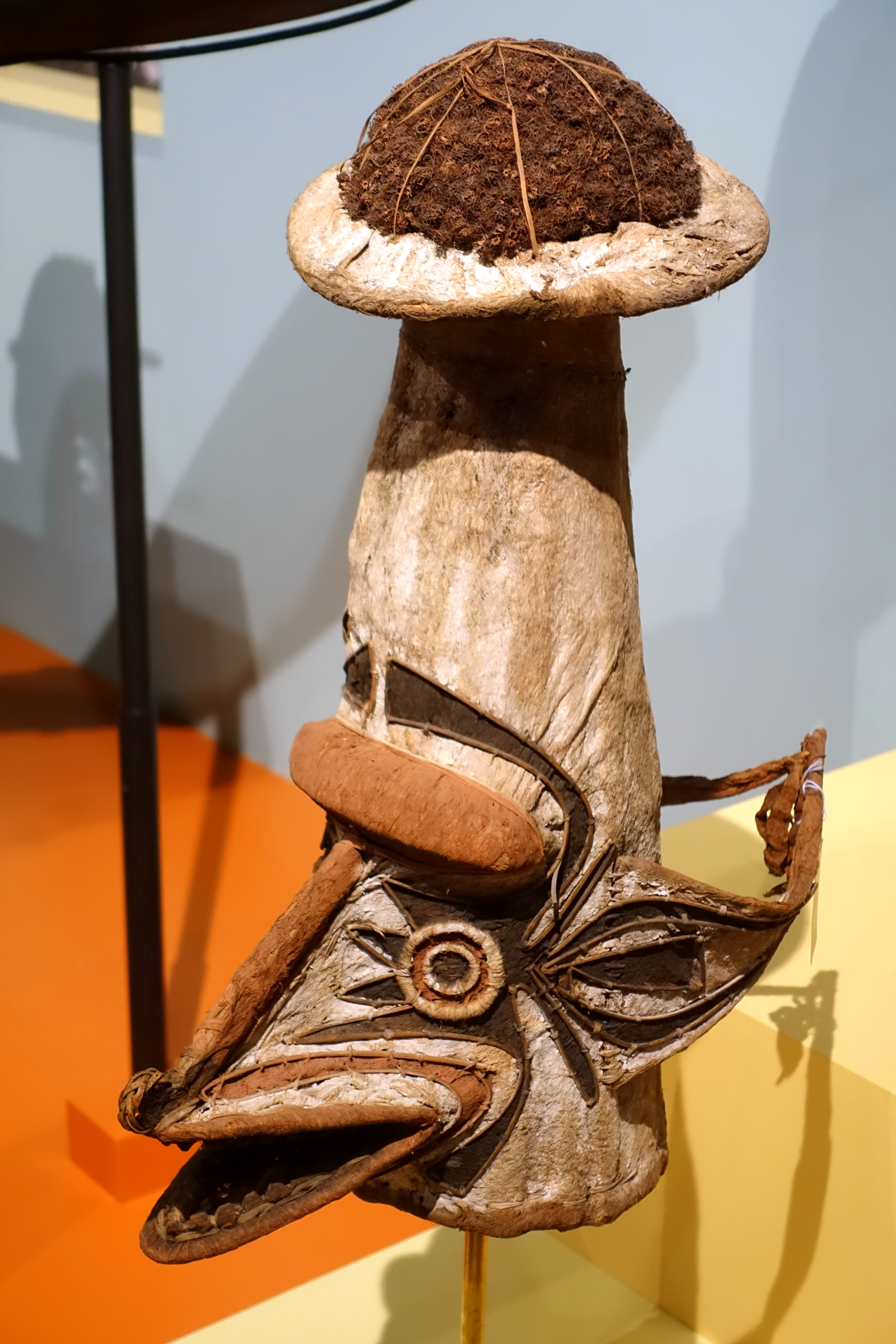 An Elema eharo mask from the Papuan Gulf, a tall conical form finished in white bark-cloth over a dark woven crown
