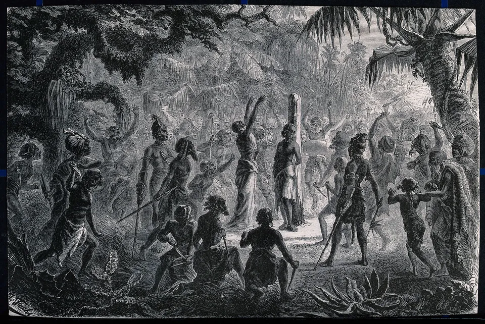 A woodcut of a night rite in a forest clearing: a figure is bound to a post at the centre while a crowd with raised arms and knives surrounds it.