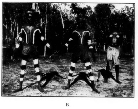 McConnel’s black-and-white photograph of the Wik-Mungkan paka paka ceremony: two men with white body markings stand while three others bend low in front of them.