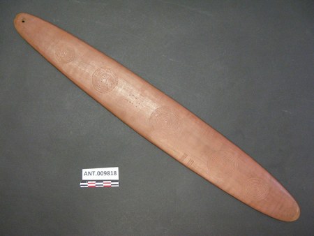 Incised bull-roarer from the Musgrave Ranges, South Australia — the Pitjantjatjara heartland; concentric-circle design, single end perforation....