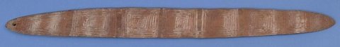 Long, flat Nyulnyul bullroarer with a rounded outline, a small hole near one end and dense incised geometric panels across its face.