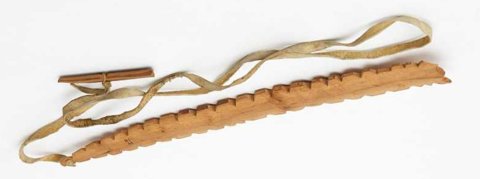 Chipewyan notched wooden bullroarer with skin thong and cross-pin, H1.65.
