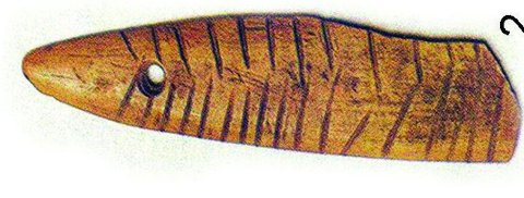 Nahal Hemar bone plaque, orange-brown, pierced near one end and incised with repeated angular lines.