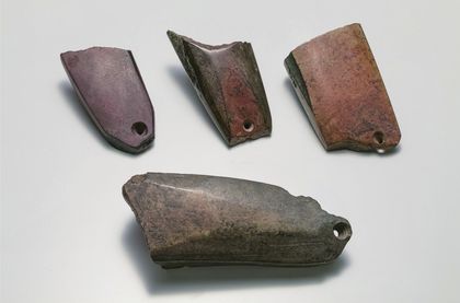 Photo 2: the four Kawajiri pieces — three reworked fragments above no. 2, the largest and heaviest.