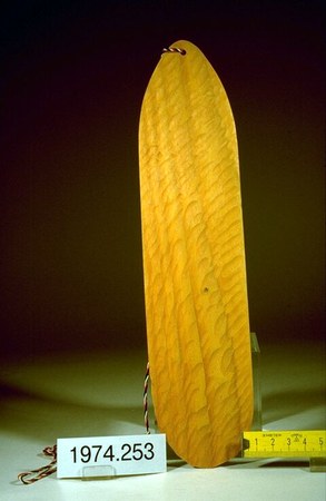 A German wooden Schwirrholz toy, a smooth pale oval blade strung with a cord through holes at each end — the same folk-toy design as the rhombe...