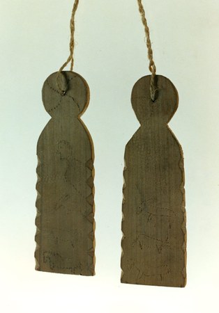 A pair of Basque furrun-farra wolf-scarers from the Musée Basque, their notched edges and pokerwork livestock figures burned into the wood; the...
