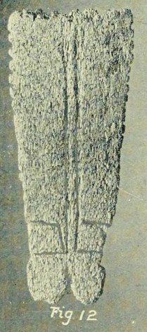 The Okawa whalebone bullroarer itself — Dendy's fig. 12: paired grooves run the length of the blade, the edges are set with ornamental notches,...