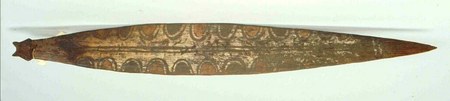 A painted flat wooden board from Aurimbit, on the eastern Sepik's southern tributaries: rows of arched, scalloped painted bands run its length...