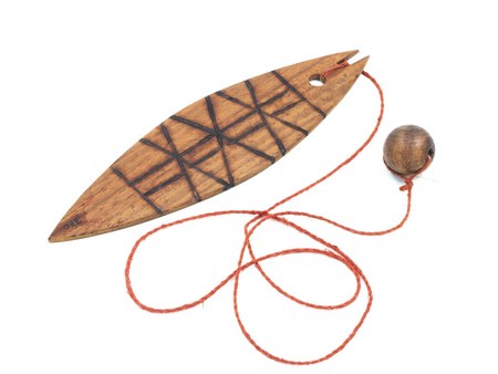 A Brazilian zunidor, its blade carved in crosshatched diamonds and finished with a wooden ball on its cord, stands in for the berra-boi of...