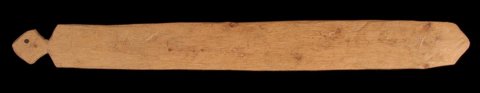 A Toma guri from Nzérékoré, Guinea, a long pale wooden blade with a pierced diamond-shaped end and a pointed opposite tip.