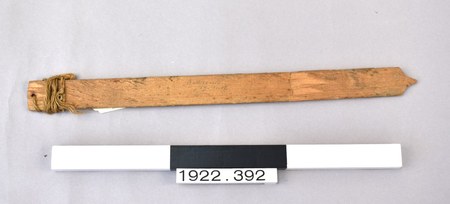 The Ballycastle bull-roarer itself — plain pine lath with cord-wrapped end hole, the Co. Antrim specimen behind Haddon's 1898 plate. MAA...