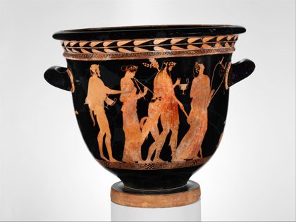 A red-figure bell-krater showing Dionysos among maenads and satyrs, one playing the double flute — a scene of Dionysiac revelry, not a picture...