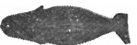 A whale-shaped baleen imigdlugtaoq from Point Barrow, its serrated flukes at one end and the cord hole at the other.