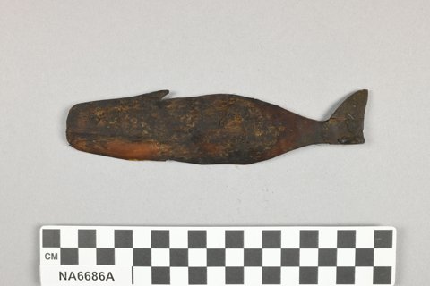 A whalebone blade cut as a whale, fin and flukes, from Van Valin's 1919 Point Barrow trip (Penn NA6686A).