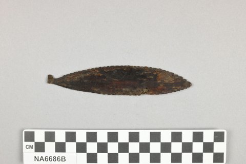 Partner to the whale-shaped blade from the same 1919 trip: a slim, notch-edged whalebone ellipse.