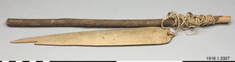 A complete bull-roarer rig from Nggela (Florida Islands) in the central Solomons — pale lance-shaped blade, twisted cord, and dark...