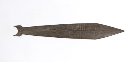 A decorated bull-roarer (bromhout) from the Netherlands New Guinea highlands, before 1959: a dark wooden blade incised with fine crosshatching,...