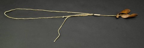 A long braided cotton cord ending in two dried, wing-shaped fruit husks.