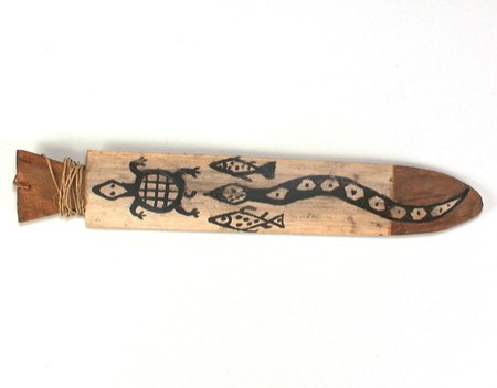 The Kalapálo painted matapu documented here — a pale wooden blade painted in black with turtle, fish, and diamond-backed snake motifs, fiber...
