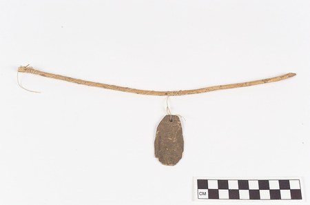 The Lenca whip-style roarer documented here — a small end-pierced stone blade slung by cord from its bent whip stick — collected at...