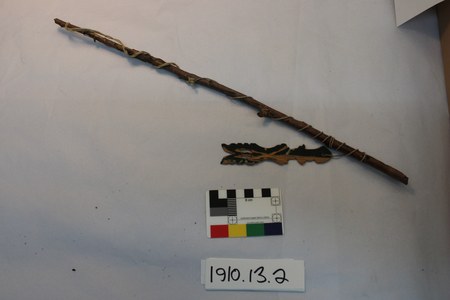 Sotho bull-roarer: carved and painted zigzag slat tied to its long swinging stick, Orange Free State, South Africa.