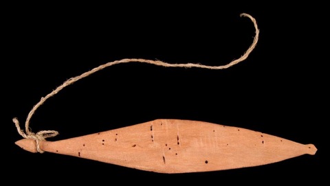Child’s red-stained wooden rhombe from the Rio Urubamba, accession 71.1980.61.49.