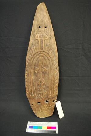 The carved face of the monumental Baramura ceremonial bullroarer, British Museum Oc1912,1217.5.