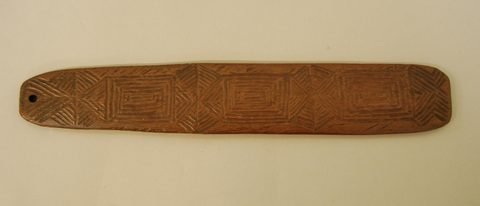 The Kalgoorlie-acquired blade, its face incised with concentric rectangles and hexagons.