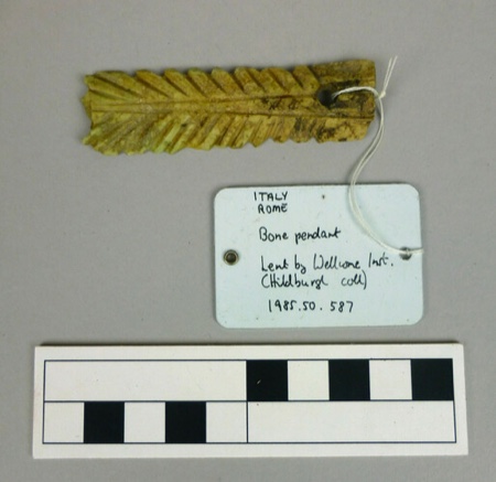 Serrated bone strip carved as a feather, with a single perforation at the plain end, bought in Rome in 1910.