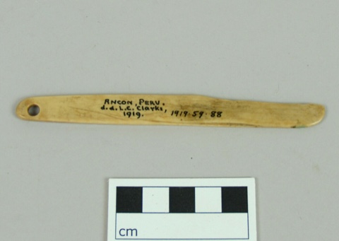 The longer of the two Ancón laths, tapering to a bevelled tip, with a clean unworn perforation at the near end.