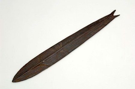 A dark wooden blade with a forked, fish-tail tip and incised bands, from a south-coast Netherlands New Guinea collection assembled before 1956;...