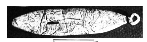 The Fontalès blade, recto: a fish-shaped bone lamina engraved with a salmonid, ending in a pierced ring that reads as the tail.