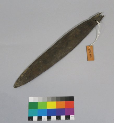 The Abelam ulke bullroarer itself, collected by Gerd Koch at Maprik in 1966: a plain, unpainted wooden blade with a small forked notch and a...