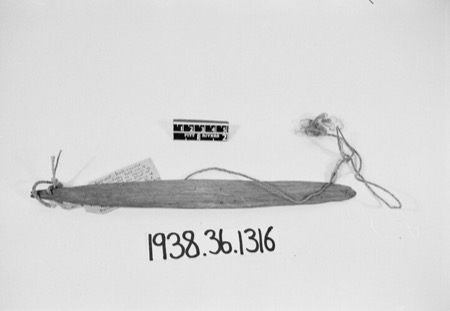 Arawe Pagiwar bullroarer from Kandrian, with its cord attached.