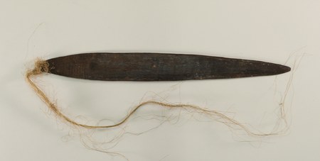 Bull-roarer with original fiber cord, collected in the 'grass country' between the Sepik and Keram Rivers — the Banaro homeland; the museum...
