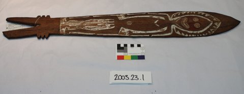 An Orokolo blade carved with a whole human figure, face reddened with ochre (PRM 2003.23.1).