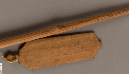 Baniwa bull-roarer, Rio Içana, NW Amazonas, Brazil — notched crown, incised design, cord hole at the base; with its swinging stick.
