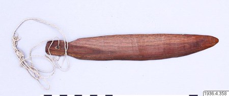 Mataco (Wichí) bull-roarer, Gran Chaco — a reddish-brown slat with a small perforated tab and a long plaited cord, unmarked apart from its...