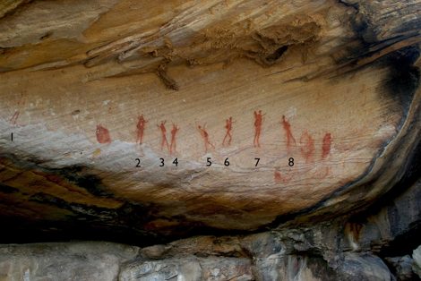 Doring River shelter, Western Cape, South Africa: a row of eight red human figures, interpreted as depicting bull-roarers in use in a...