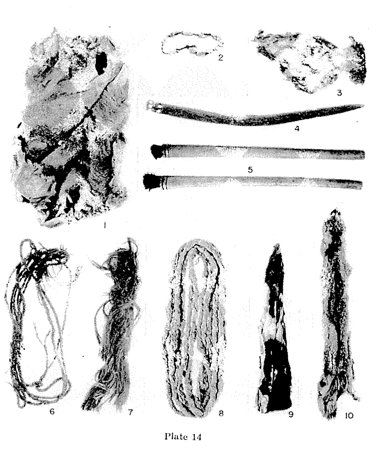 The full burial inventory: basket, skins, cordage, shells, prayer sticks — the blade is no. 4.