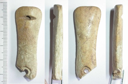 Four views of the worked bone: an oval perforation through the wide end, and a circular hole broken out into a notch at the base.