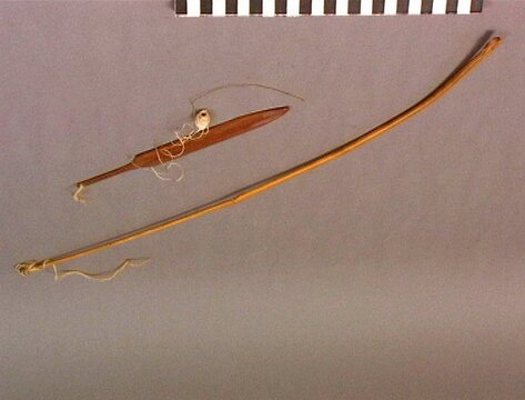 The Karo dengeng-dengeng itself: a lance-shaped bamboo blade hanging from the tip of its long, flexible bamboo stock.