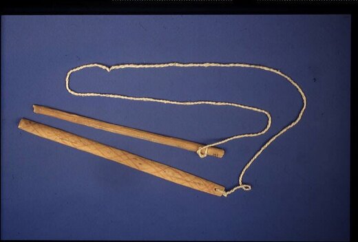 The Pima/Akimel O’odham Wihoewiketeke itself: painted slat, long cord, and separate handle, collected by H. Ten Kate and figured by Schmeltz in...